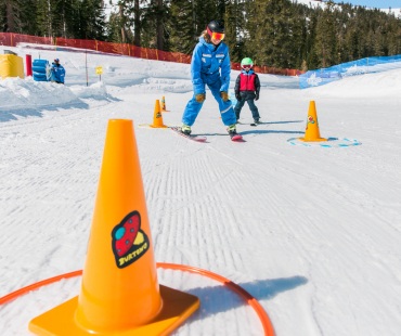 Instructor teaching young skier Instructor teaching young skier