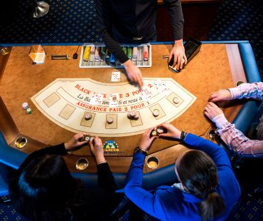 People playing table games at the casino People playing table games at the casino