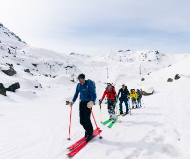 Skiers hiking through the snow Skiers hiking through the snow