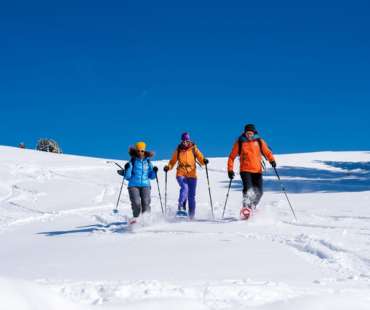Group of friends snowshoeing at Val Gardena Group of friends snowshoeing at Val Gardena