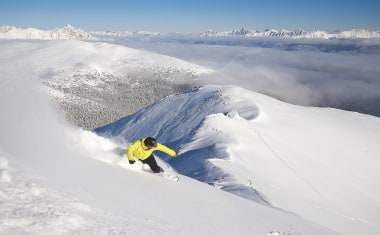 Snowboarder at the Peak of Marmot Basin