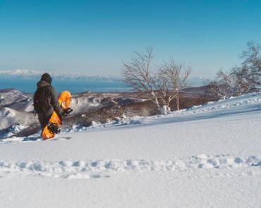 Snowboarder overlooking Resort Snowboarder overlooking Resort
