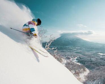 Skier at Niseko with Mount Yotei in the background Skier at Niseko with Mount Yotei in the background